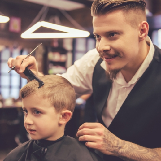 A parent styling a child's hair with a smile, showcasing simple and practical kids' hairstyle maintenance tips.