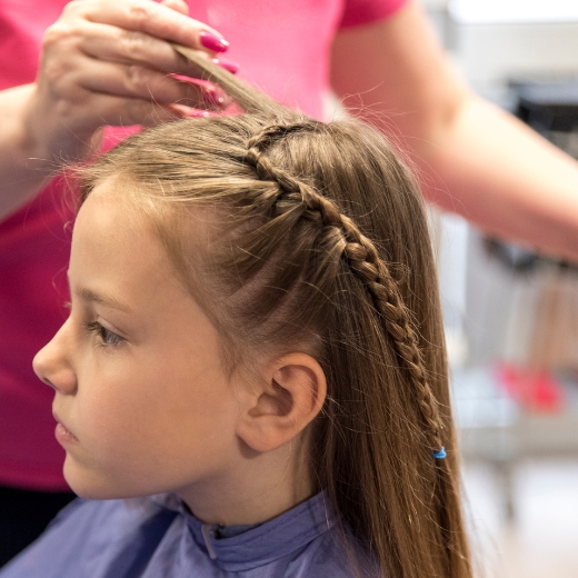 Girl taking a photo at a salon for Girls' Hairstyles tips