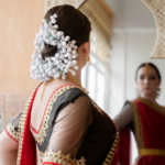 A beautiful young woman dressed in a traditional sari, adorned with the classic khopa (bun) hairstyle, exuding grace and cultural elegance.